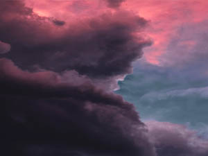 Image of looming dark clouds against a pink sky