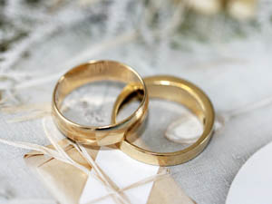 Image of two wedding rings resting on a decorated table